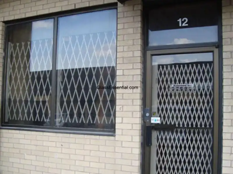 Metallic barrier folded neatly for storefront protection