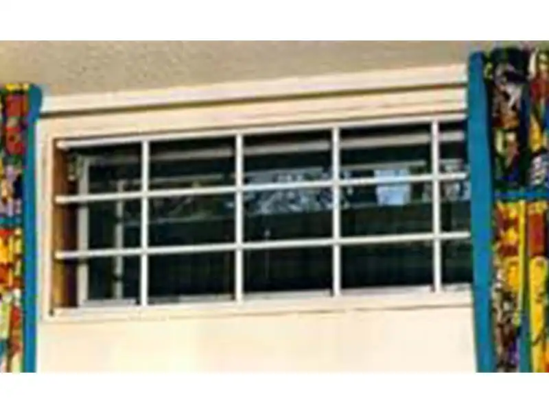 Secure your home with a touch of tradition using a Colonial-themed window security grille.